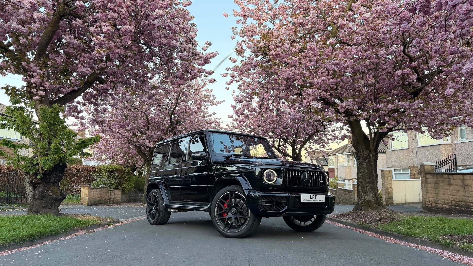 Black Mercedes G63 under cherry blossom in Bradford